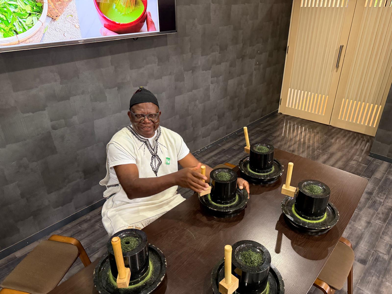 Pa Fru at a tea-grinding session
