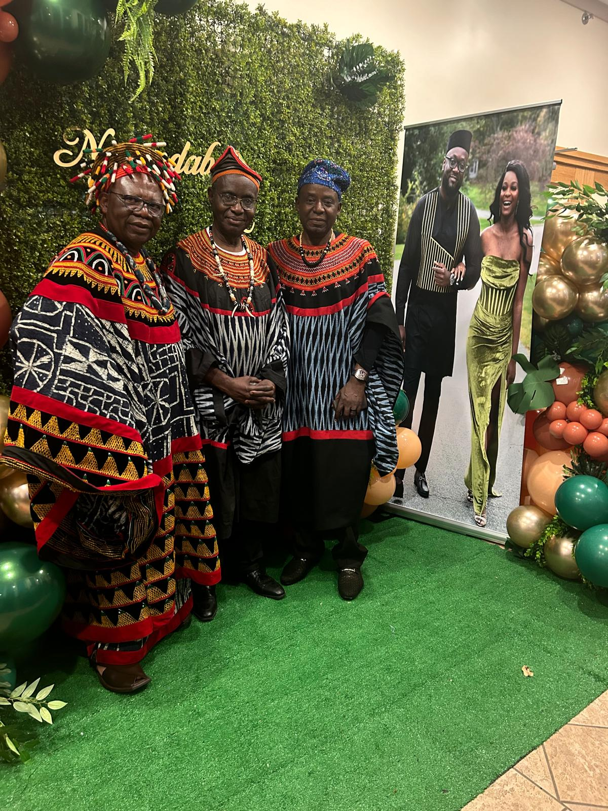 Three notables in traditional dress at a celebration