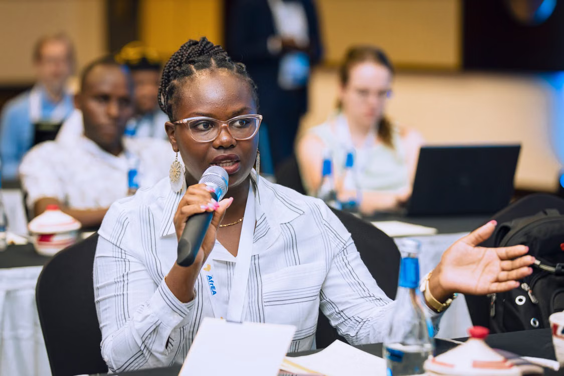 A speaker making her point at a debate forum